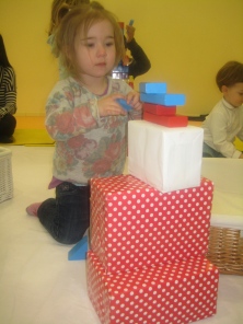 Nora building towers at Toddler Sense.